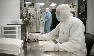 A scientists works in a cleanroom